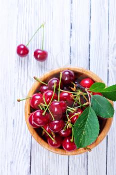 fresh cherry in bowl and on a table