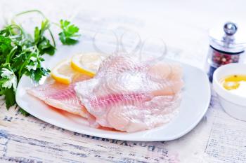 fish fillet on plate and on a table