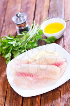 fish fillet on plate and on a table