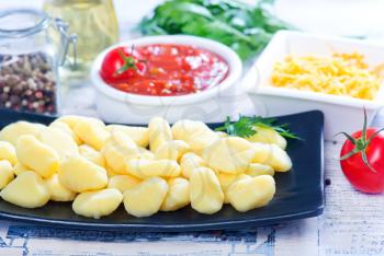 potato gnocchi with sauce on the kitchen table