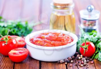 tomato sauce in bowl and on a table