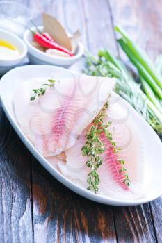 fish fillet on plate and on a table