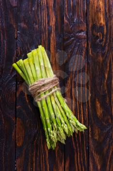 green asparagus on the wooden table, fresh asparagus