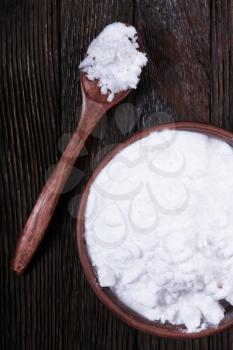 baking soda in bowl and on a table