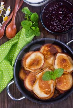 pancakes in pan and on a table