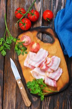 smoked bacon on wooden board and on a table