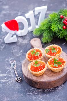 canape with red salmon caviar on the wooden board