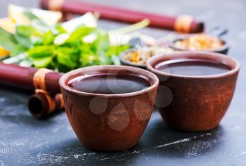 fresh tea in cups and on a table