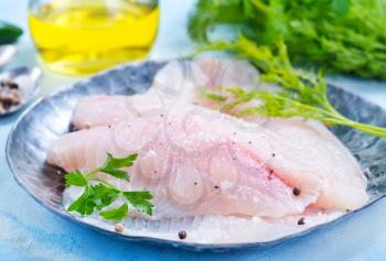 raw fish fillet on the metal plate