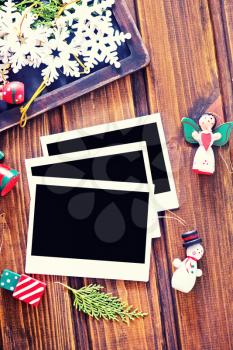 Vintage photo frames decorated for Christmas on the wooden board 