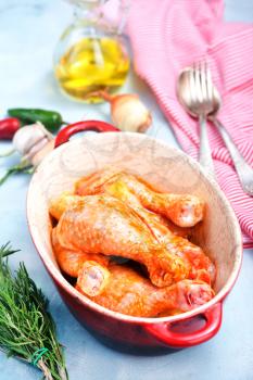chicken legs with marinade in the bowl