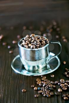 coffee beans in metal cup and on a table