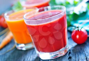 fresh vegetable juice in the glass and on a table