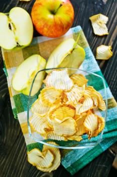 apple chips in bowl and on a table