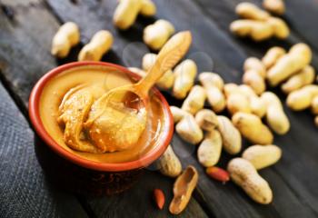 peanuts butter in bowl and on a table