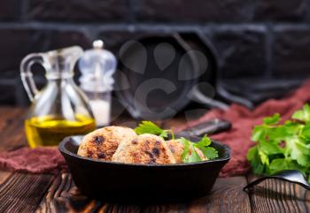 fried cutlets in pan and on a table