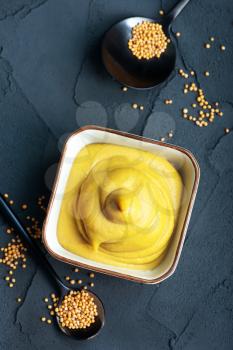 mustard in bowl and on a table