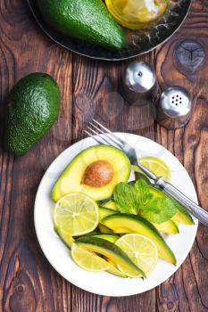salad with avocado and lime on plate
