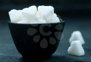 white sugar in bowl and on a table