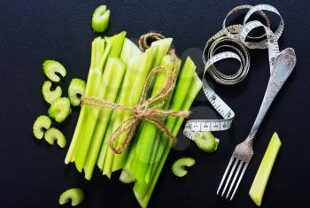 raw celery on black table, fresh celery