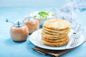 potato pancakes on plate and on a table