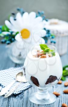 desert with cream and dry almond in glass