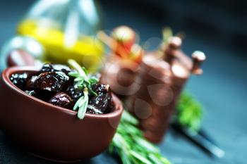 dry olives with salt and oil on a table