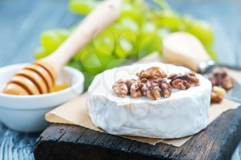 camembert with honey on board, stock photo