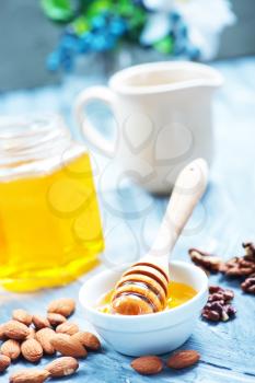 honey with nuts on a table, stock photo