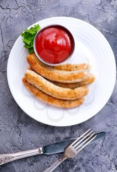 sausages with sauce on plate, stock photo