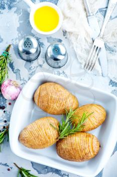 baked potato with rosemary and garlic in bowl