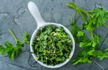 dry parsley in bowl and on a table