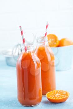 fresh fruit juice in bottle and on a table