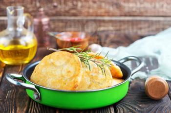 potato pancakes in pan and on a table