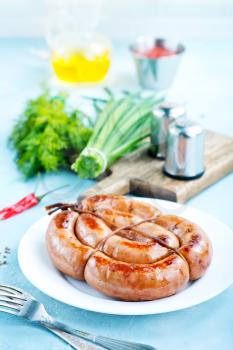 sausages on white plate and on a table