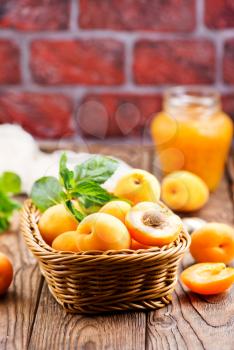 fresh apricots in basket and on a table