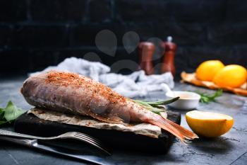 raw fish with spice and salt on a table