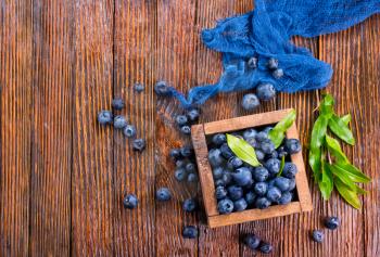 blueberry in wooden box and on a table