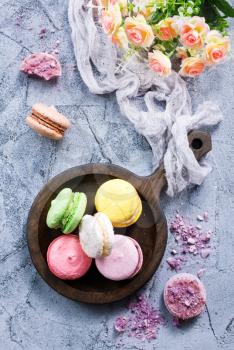 macaroons on wooden plate and on a table