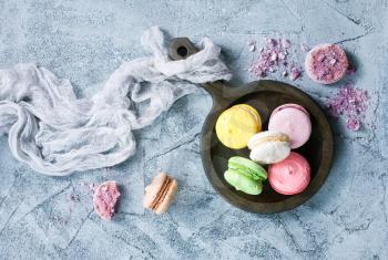 macaroons on wooden plate and on a table