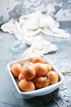 raw eggs in bowl and on a table