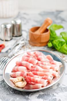 bacon with spice on the metal plate, stock photo