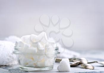 white sugar in glass bowl and on a table