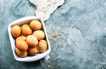 raw eggs in bowl and on a table