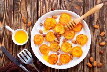 baked apricots with honey and nuts on a table