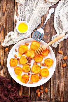 baked apricots with honey and nuts on a table