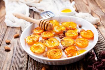 baked apricots with honey and nuts on a table