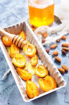 baked apricots with honey and nuts on a table