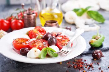 caprese salad on plate and on a table