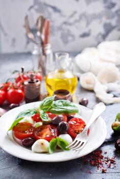 caprese salad on plate and on a table